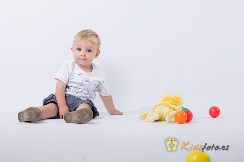 niño camiseta blanca peluche amarillo pelotas